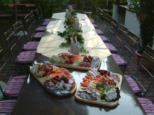 a long table with three plates of food on it at Pension St. Georg mit Moststüberl in Bad Griesbach