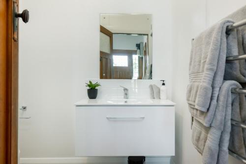 a bathroom with a sink and a mirror at Stylish on Severne in Blenheim