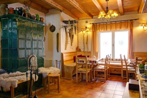 a dining room with a table and chairs and a window at Kaktusz Villa Heviz in Hévíz