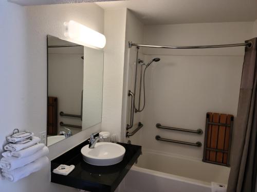 a bathroom with a sink and a shower at Motel 9 Las Cruces in Las Cruces