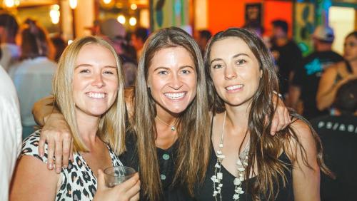 three women posing for a picture at a party at Youth Shack Backpackers Darwin in Darwin