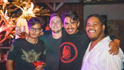 four men posing for a picture at a party at Youth Shack Backpackers Darwin in Darwin