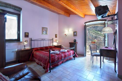 a bedroom with a bed and a chair and a table at Il Belvedere in Civita