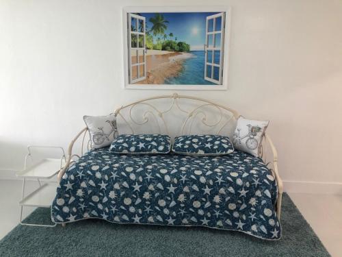 a bedroom with a bed and a picture of a beach at The Blue Island in Miami Beach