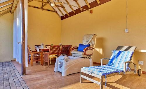a living room with rocking chairs and a table at Sanbonani Hotel in Hazyview