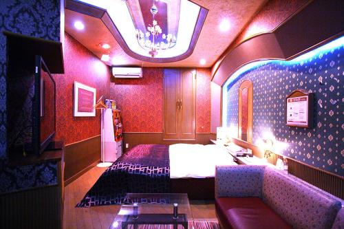 a hotel room with a bed and a couch at Hotel Ohirune Racco Sakai (Adult Only ) in Sakai