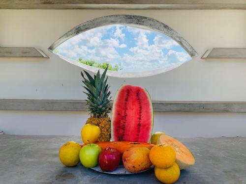 a plate of fruit in front of a window at Villa Antilope in Cancún