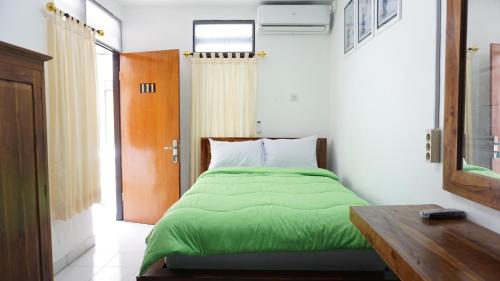 Кровать или кровати в номере Pusana Village Bali