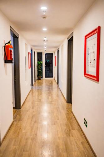 an empty hallway with wood floors and a painting on the wall at GoldenKeys Inn in New Delhi