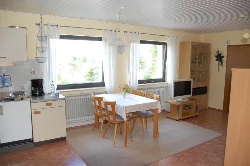 a kitchen with a table and chairs in a kitchen at Haus Barbara in Hilders