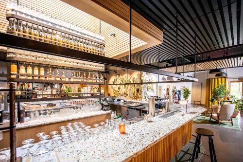 a bar with a lot of glasses on the counter at Notiz Hotel Leeuwarden in Leeuwarden