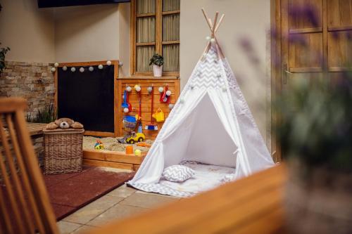 a small play room with a teepee tent at City Residence Apartment Hotel in Košice