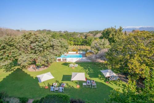 an overhead view of a lawn with tables and chairs and a pool at The Cellars-Hohenort in Cape Town
