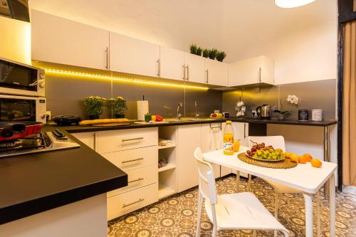 a kitchen with a table with a bowl of fruit on it at Bee Hostel in Limassol