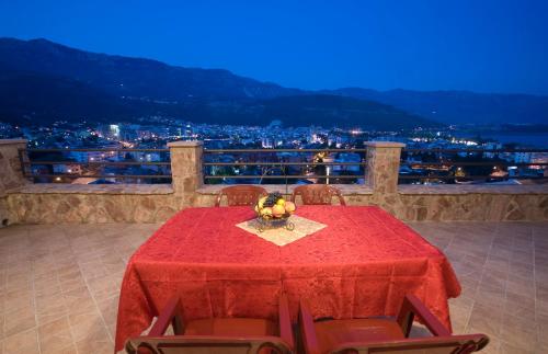 a table with a red table cloth and some fruit on it at Contessa Apartments in Budva