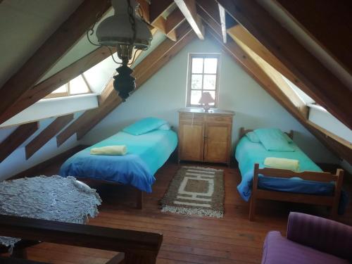 a attic room with two beds and a window at Madel's Traum in Rhodes