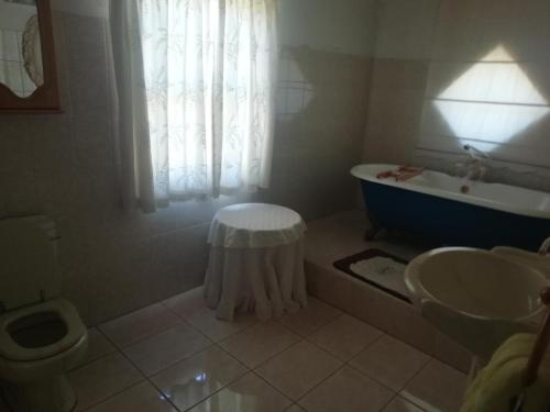 a bathroom with a tub and a toilet and a sink at Madel's Traum in Rhodes