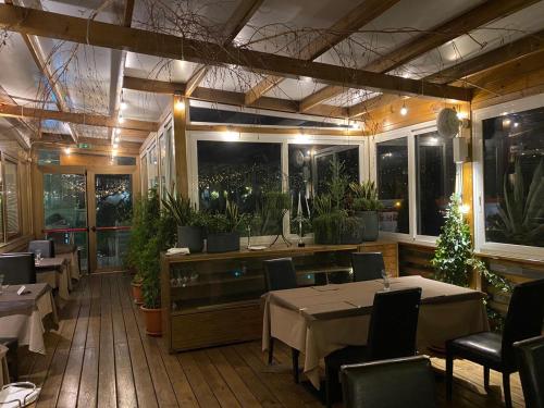 a dining room with tables and chairs and windows at Rouge Hotel International in Milano Marittima