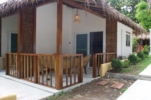 a small house with a thatched roof at Gecko Lipe Resort in Ko Lipe