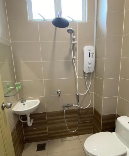 a shower in a bathroom with a toilet and a sink at Casa Hijau in Kampung Pasir Kota