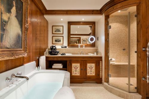 a bathroom with a tub and a sink and a shower at Airelles Courchevel, Les Airelles in Courchevel