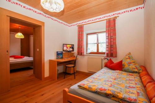 a bedroom with a bed and a desk and a table at Beim Appertinger in Truchtlaching