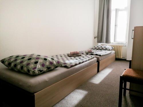 two twin beds in a room with at Hostel Vodna 1 in Košice
