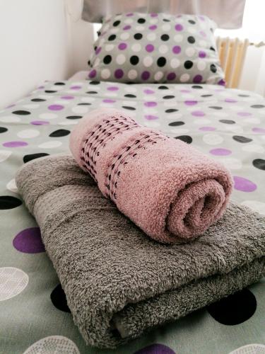 a pile of towels sitting on top of a bed at Hostel Vodna 1 in Košice