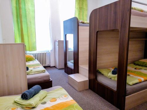 a room with two bunk beds and a mirror at Hostel Vodna 1 in Košice