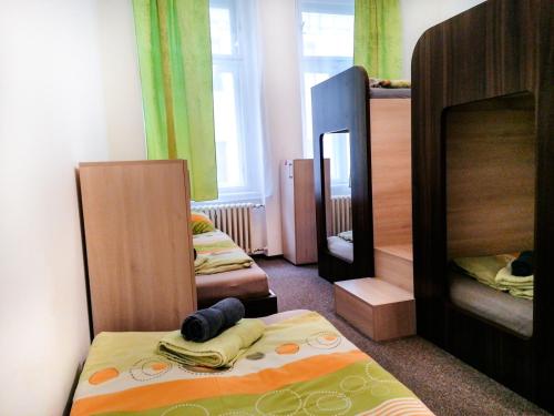 a bedroom with three bunk beds and a mirror at Hostel Vodna 1 in Košice