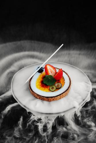 a dessert on a plate with fruit on it at Dusit Thani Dubai in Dubai
