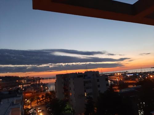 a view of a city at night with a sunset at Beki Apartment in Bar