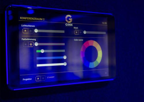 a tablet screen with the gim on it at GINN Hotel Berlin Potsdam in Teltow