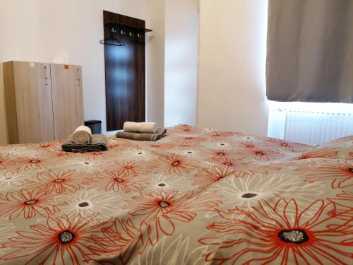 a bedroom with a large bed with flowers on it at Hostel Vodna 1 in Košice