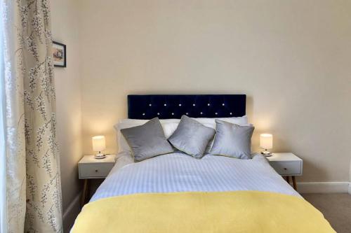 a bedroom with a large bed with two night stands at Mostyn Villa 2 Free Private Parking in Llandudno