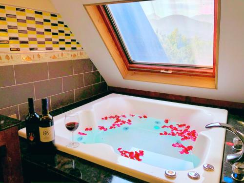 a bath tub filled with red confetti at Puli Story House in Puli
