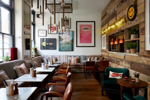a restaurant with tables and chairs in it at Artist Residence London in London