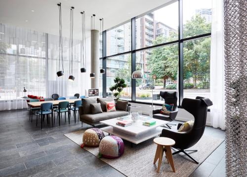 a living room with a couch and a table at citizenM Seattle South Lake Union in Seattle