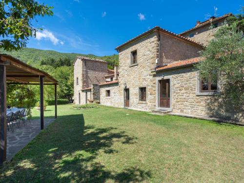 an external view of a stone house with a yard at Holiday Home La Vittoria by Interhome in Poggioni
