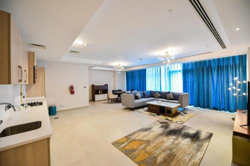 a living room with a couch and a table at Waterfront Hotel Apartment in Lusail