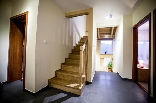 a hallway with stairs in a house at Rezydencja Pod Ochorowiczówką B&B in Wisła