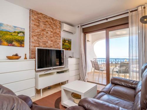 a living room with a couch and a tv at Apartment Bellavista I by Interhome in Orihuela