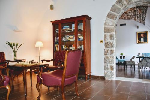 
a living room filled with furniture and a fireplace at Boutique Hotel Kazbek in Dubrovnik

