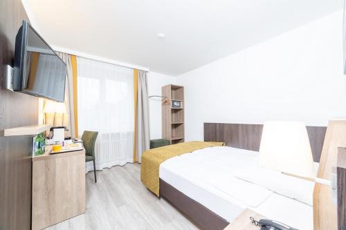 Postel nebo postele na pokoji v ubytování Hotel Alfa