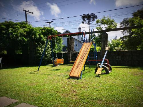 a park with a playground with a slide at Pousada Casa Rosa in Canela