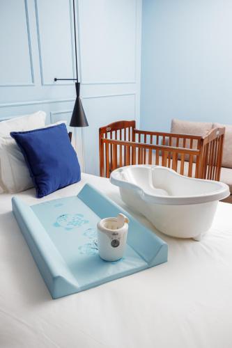 a tray with a bowl and a cup on a bed at Mercure Porto Centro Aliados in Porto