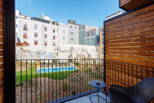 a balcony with a view of a pool and buildings at Mercure Porto Centro Aliados in Porto