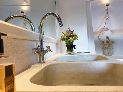 a sink in a kitchen with a vase of flowers at El Molino Estepona in Estepona