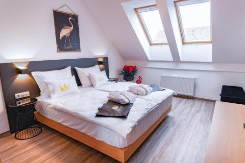 a bedroom with a large white bed with skylights at Bella Mura Golden Apartment in Moravske-Toplice