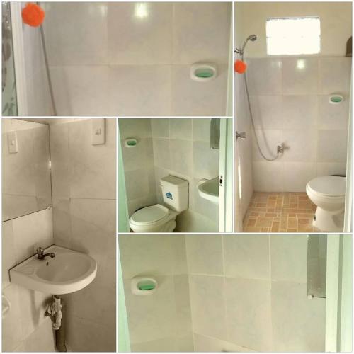a white bathroom with a toilet and a sink at Perlies Inn Balcony House in Tanay